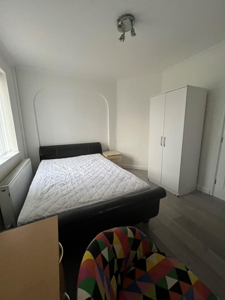 A bright and spacious double bedroom featuring ...