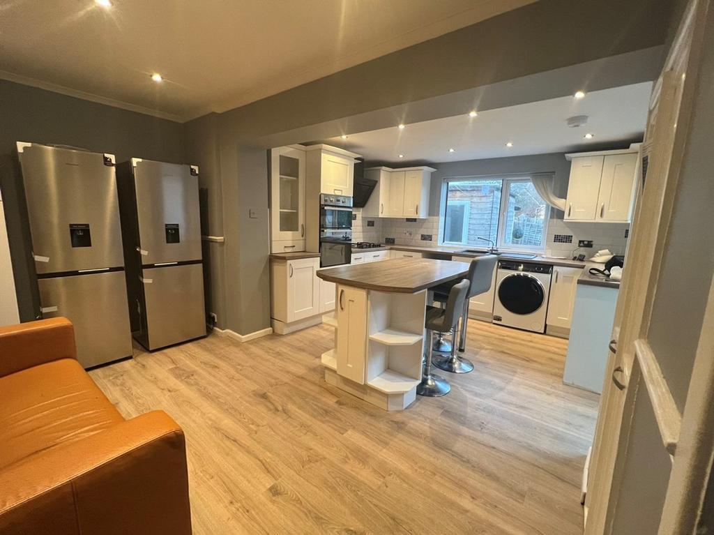 A modern and spacious kitchen with ample storag...