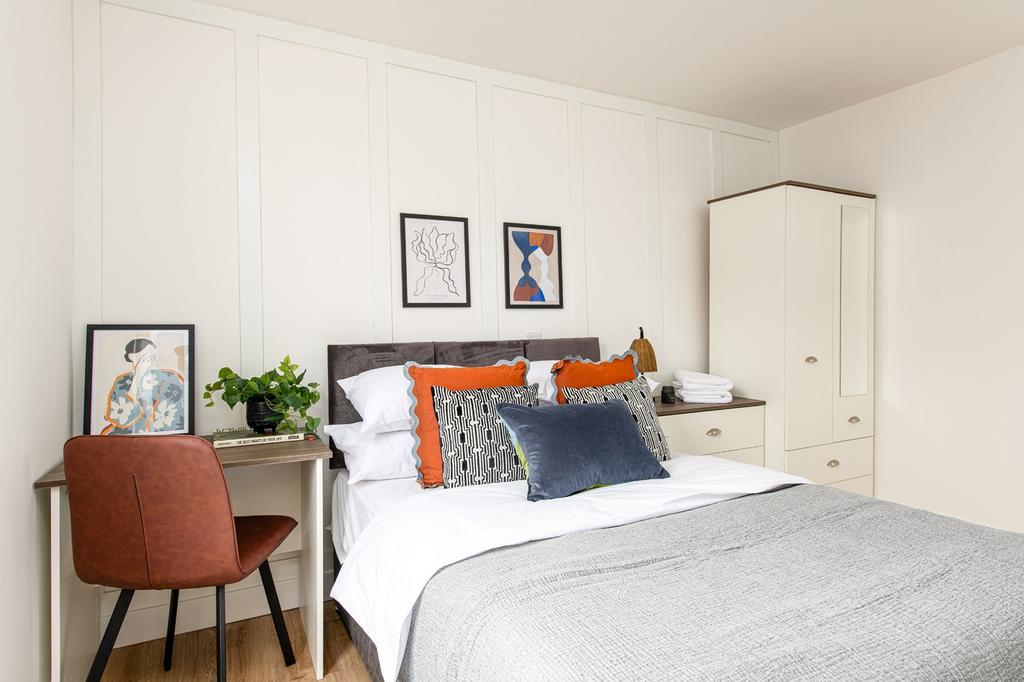 A beautifully styled double bedroom featuring a...