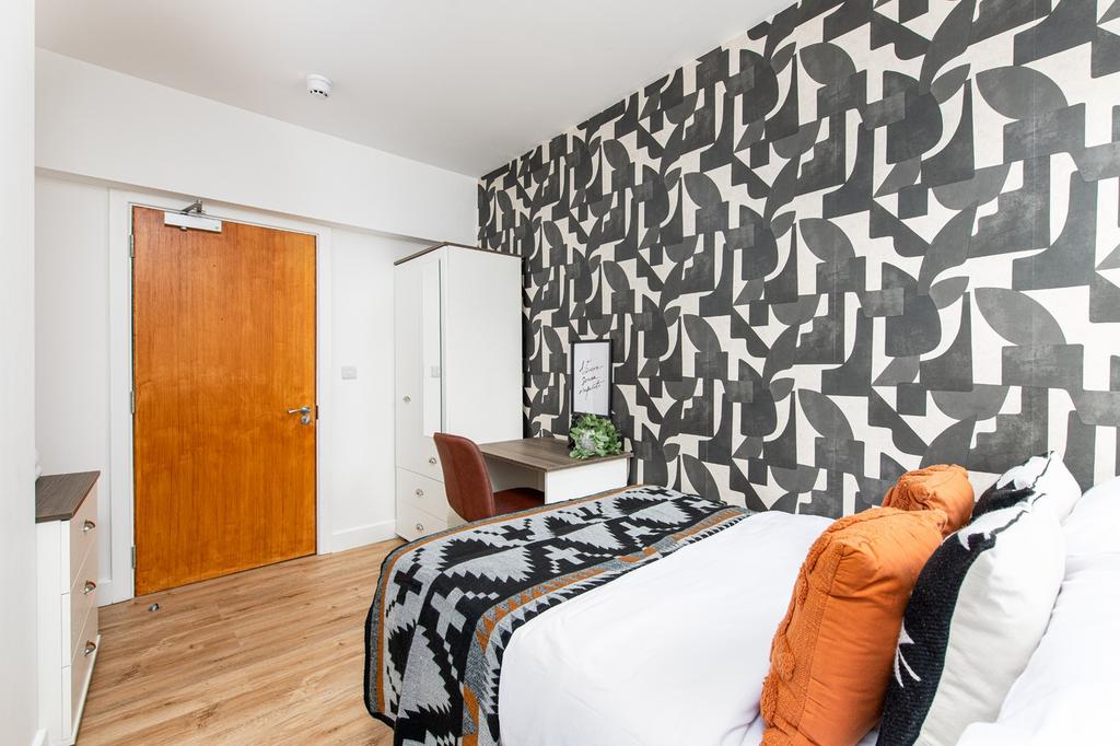 A stylish double bedroom featuring a vibrant ac...