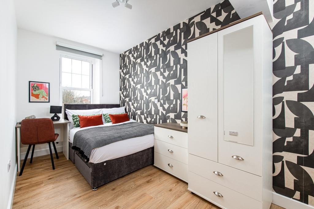 This stylish double bedroom features a comforta...