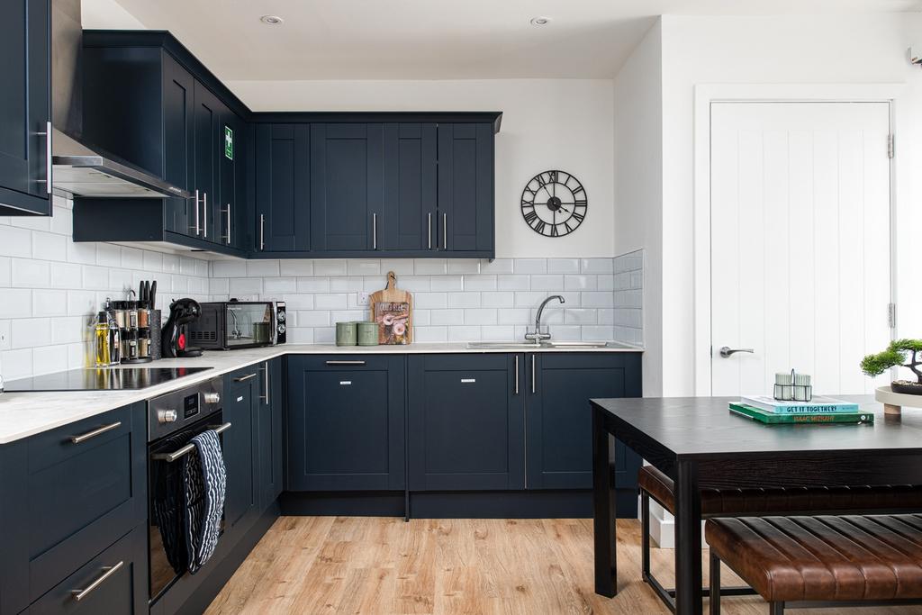 Stylish and modern kitchen featuring sleek dark...