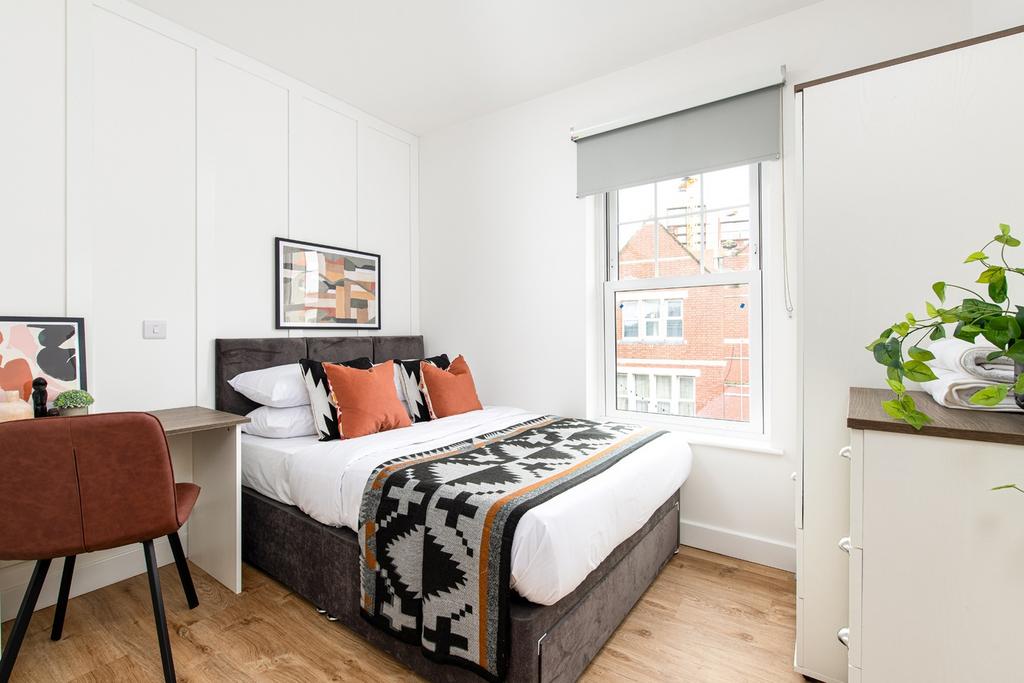Cozy double bedroom featuring stylish decor, am...