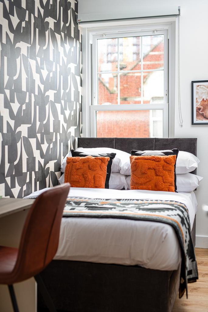 This charming double bedroom features a stylish...