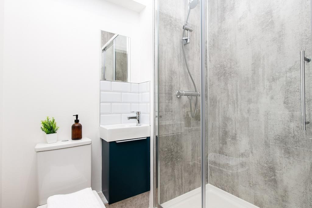A modern bathroom featuring a sleek shower and ...