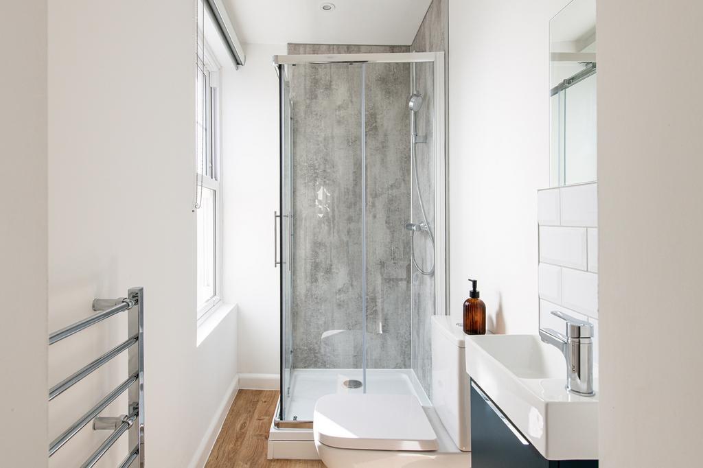 A modern bathroom featuring a sleek shower, sty...