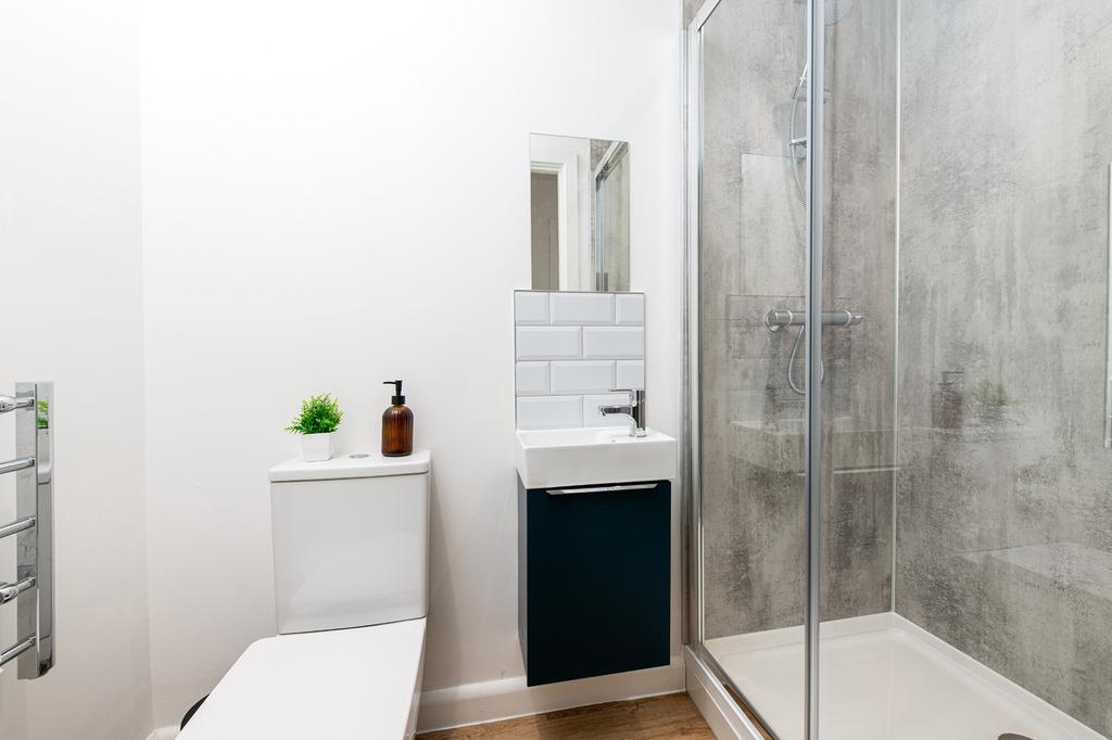 A modern bathroom featuring a sleek shower, sty...