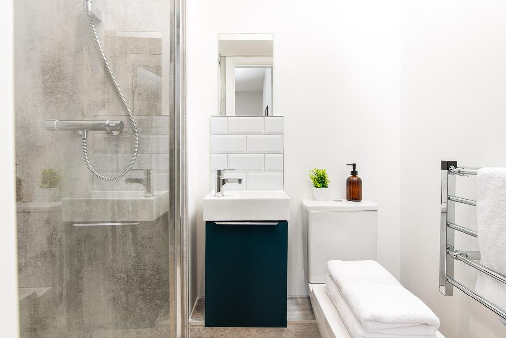 A modern bathroom featuring a sleek shower, sty...