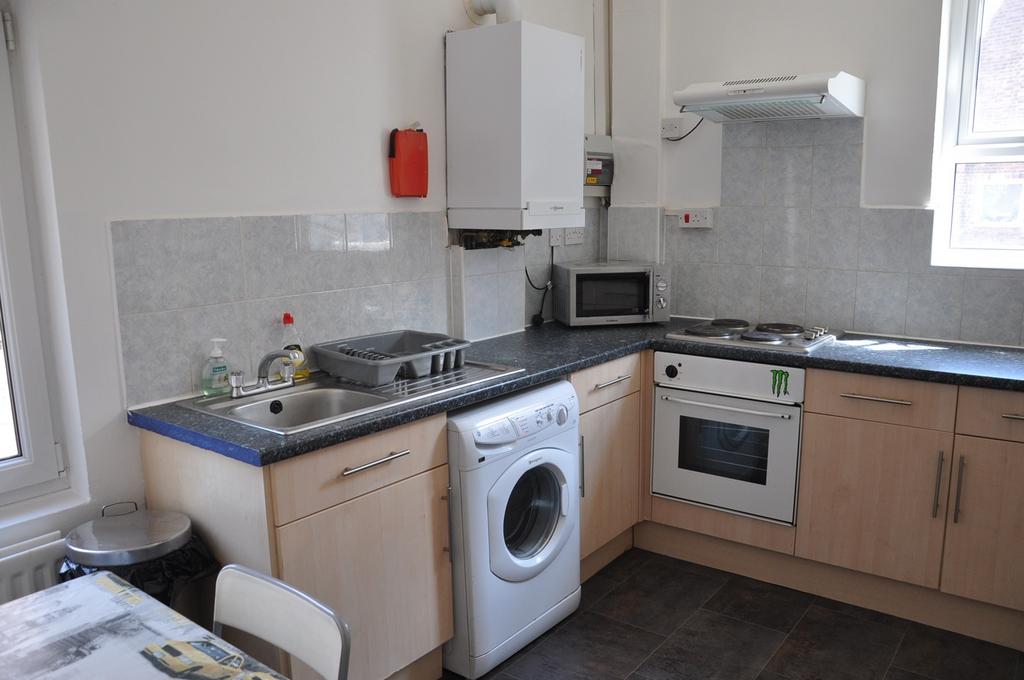 A modern kitchenette with ample space and natur...