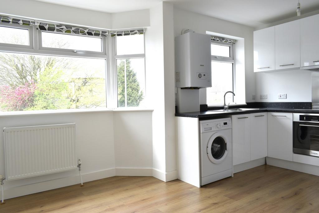 Bright and modern kitchen featuring ample natur...