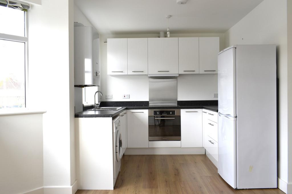 A modern kitchen featuring sleek cabinetry, a s...