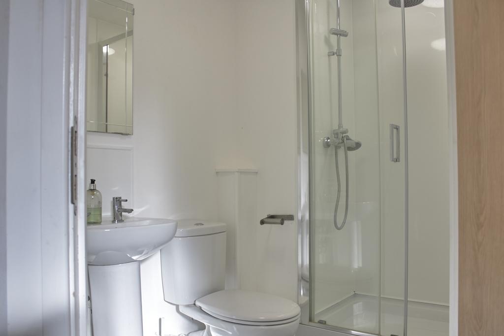 A modern and clean bathroom featuring a glass s...