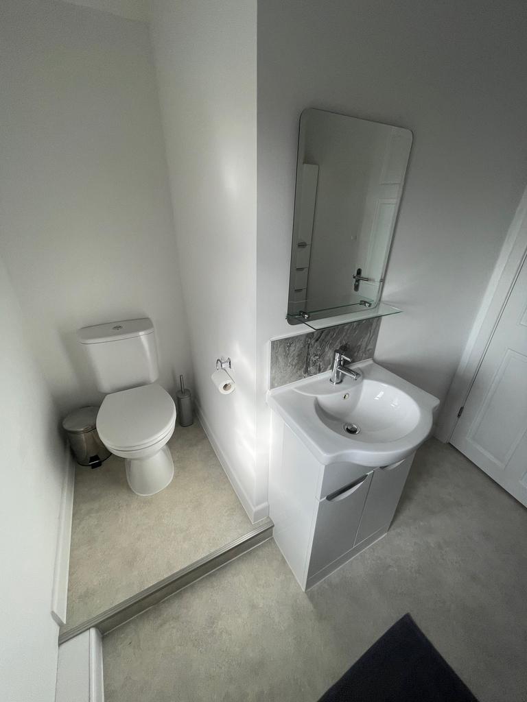 A modern bathroom suite featuring a sleek desig...