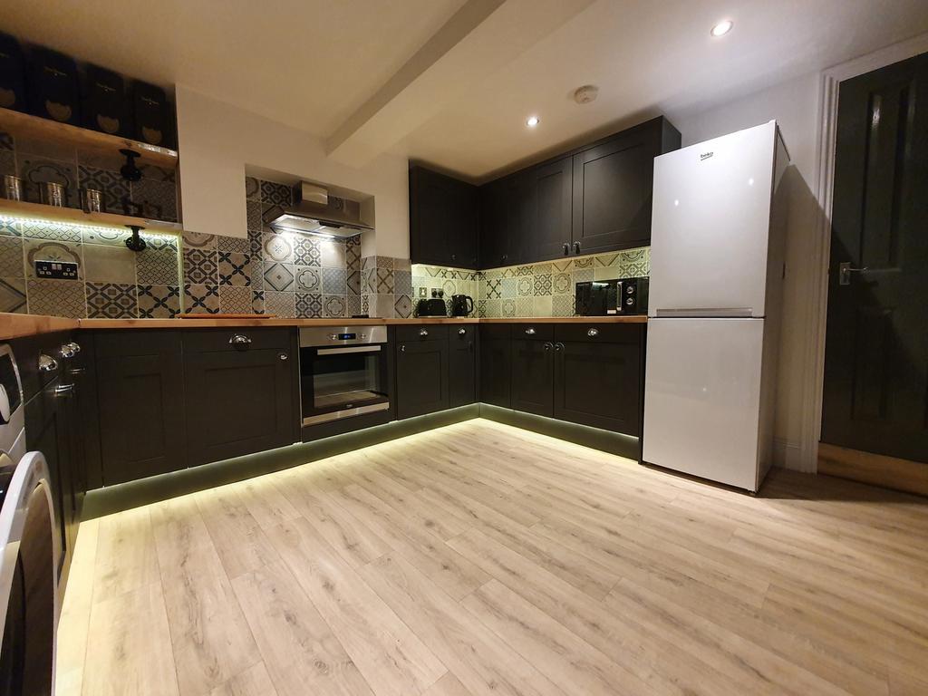 This modern kitchen features stylish cabinetry,...