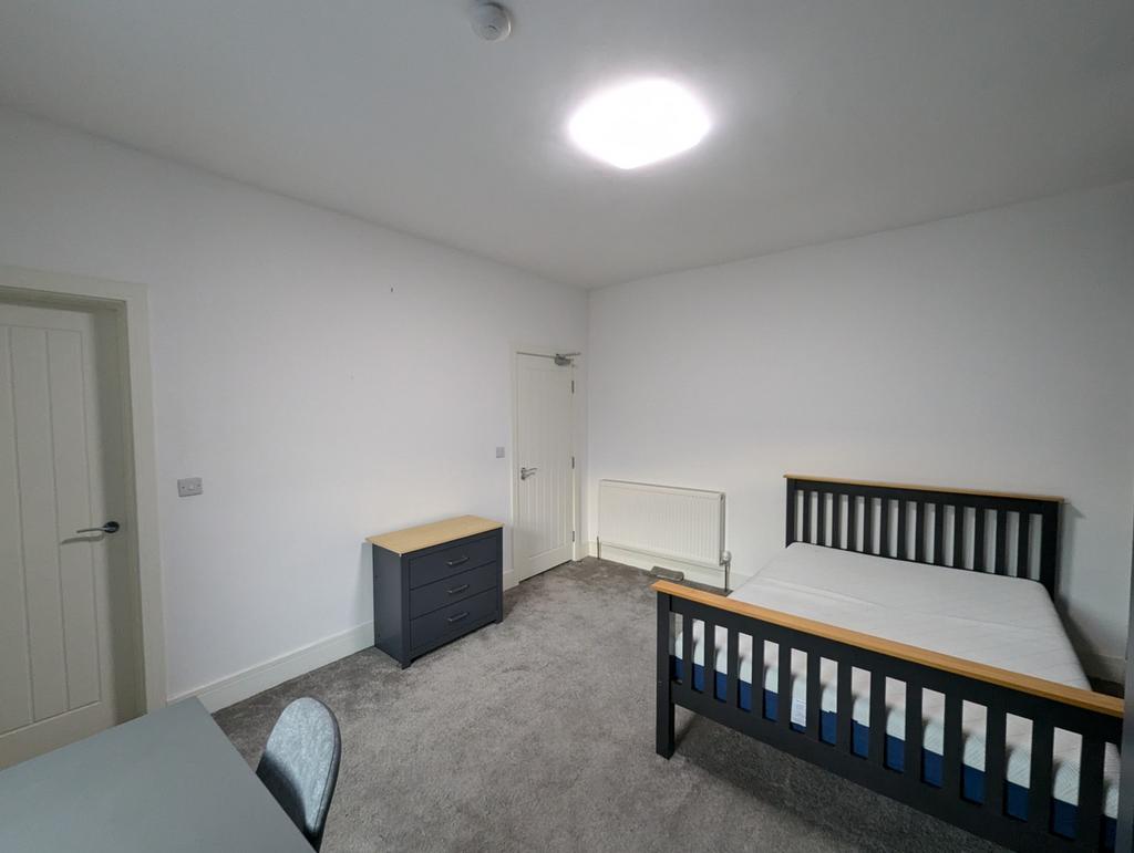 Spacious double bedroom featuring a comfortable...