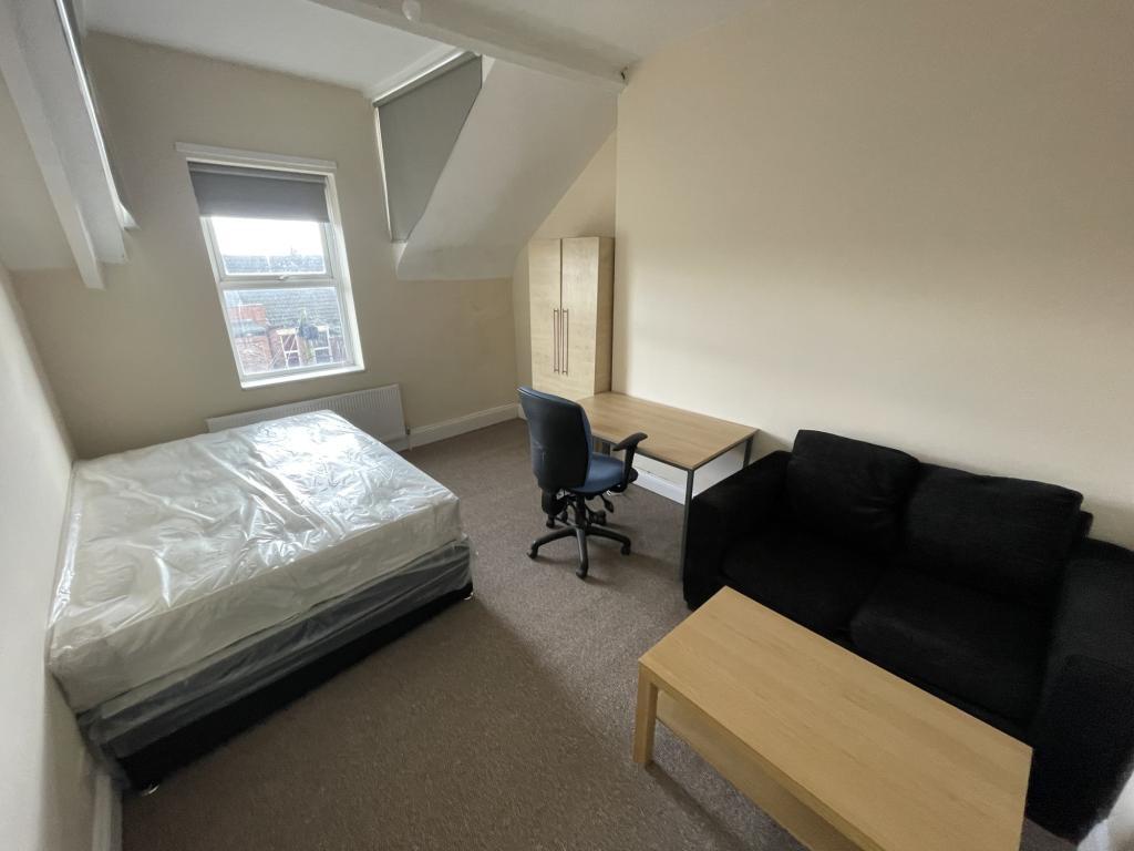 Spacious double bedroom featuring a comfortable...