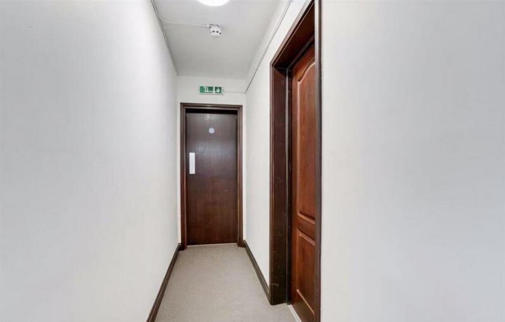 Bright and welcoming hallway leading to private...