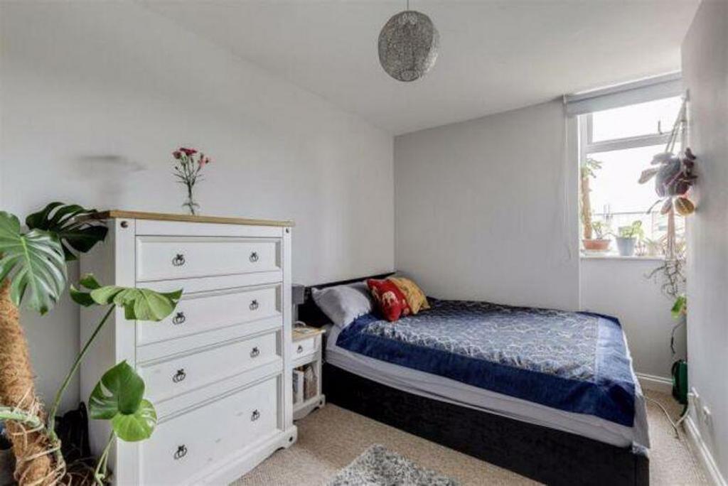 This inviting double bedroom features a cozy am...
