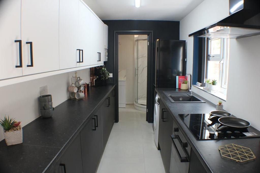 A modern kitchen featuring sleek black and whit...