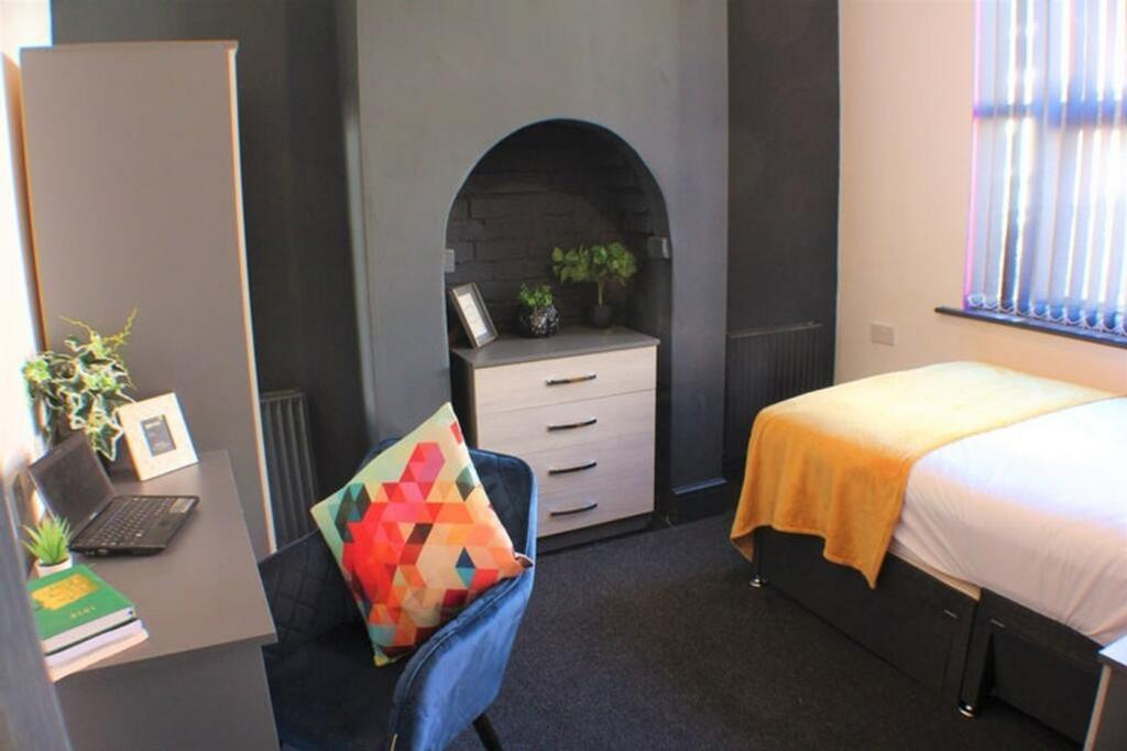 A stylish double bedroom featuring a cozy bed, ...