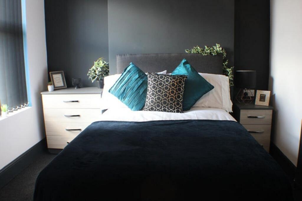 A stylish double bedroom featuring a comfortabl...