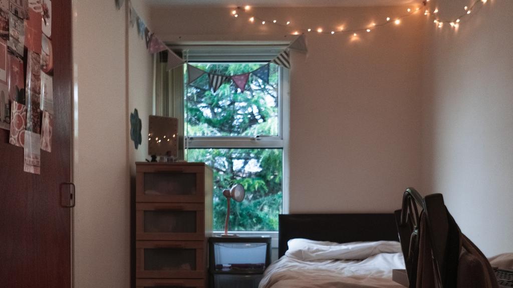 A cozy double bedroom featuring warm lighting a...