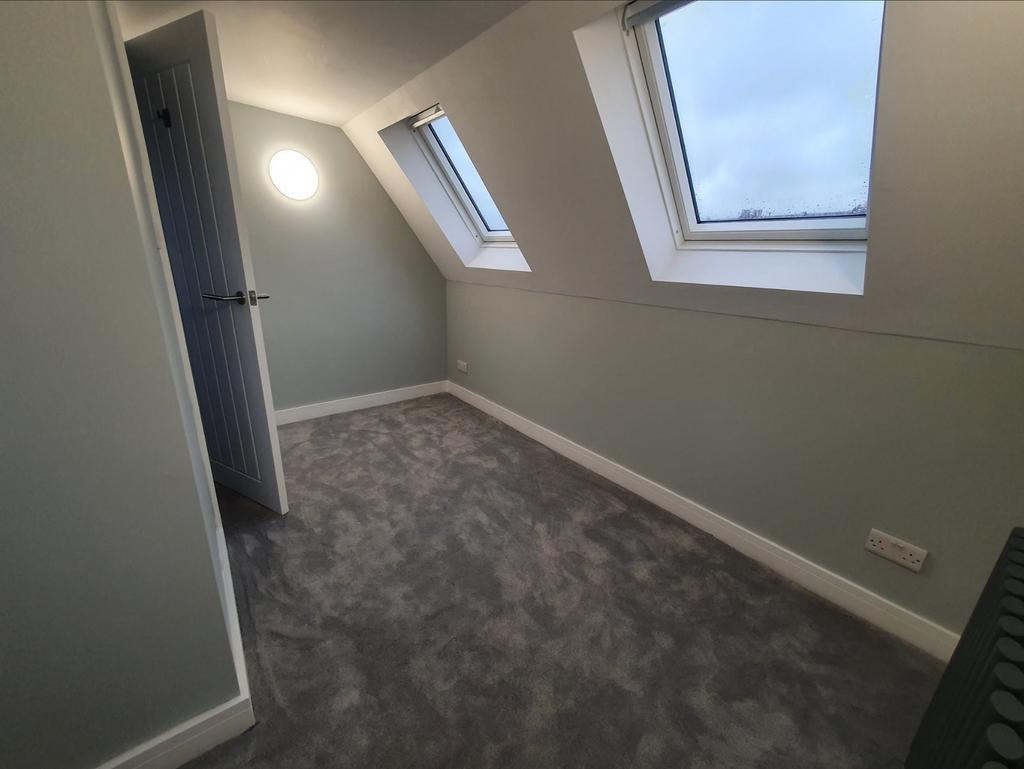 Spacious double bedroom featuring large windows...