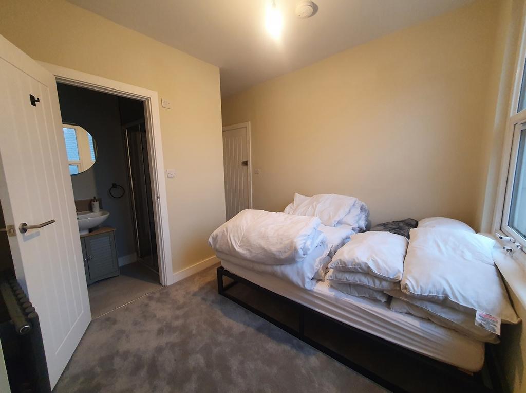 A cozy double bedroom featuring a comfortable b...