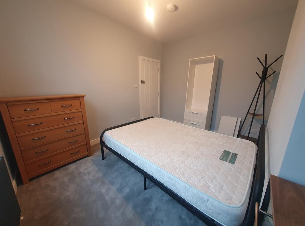 A well-proportioned double bedroom featuring a ...