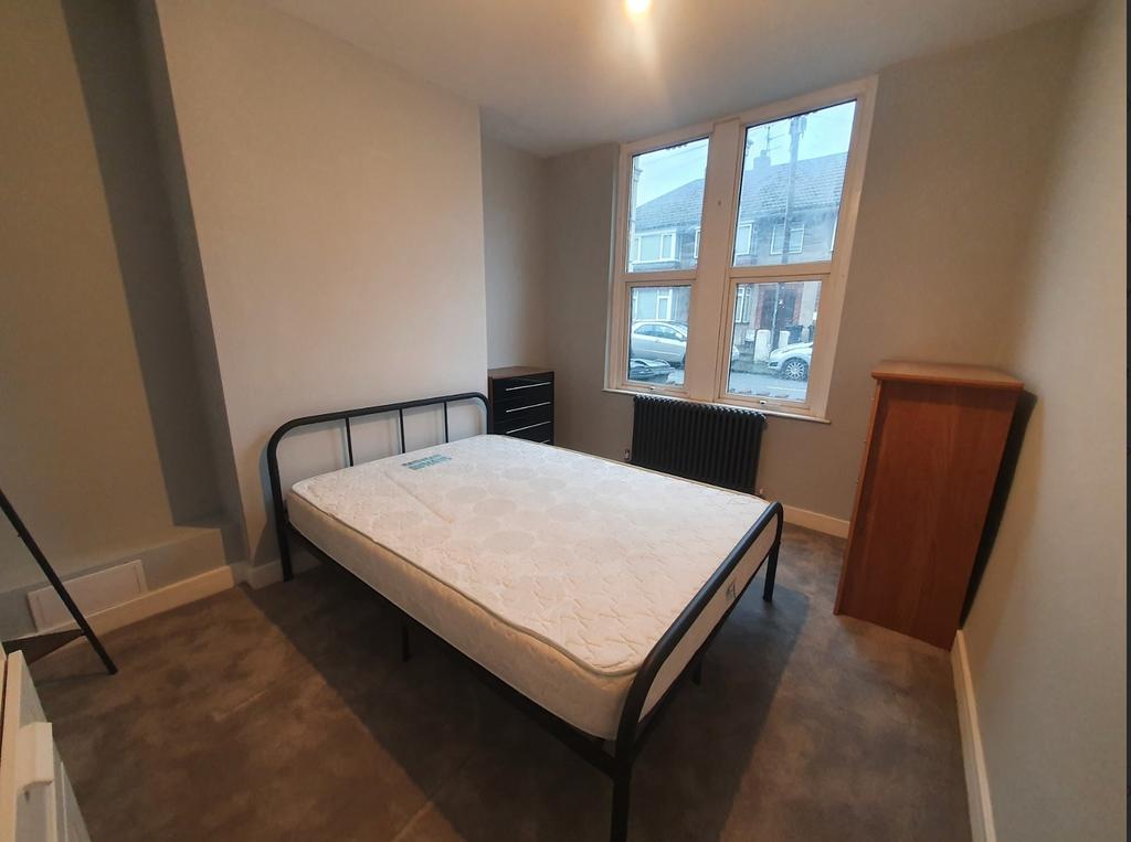 This inviting double bedroom features large win...