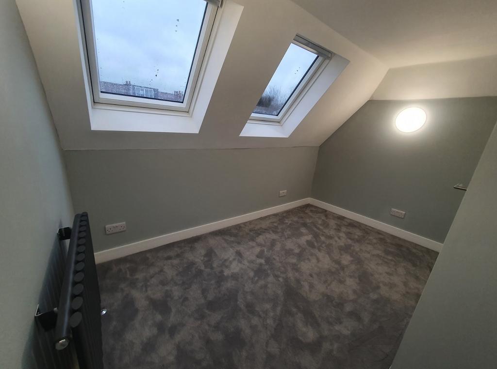 This stylish double bedroom features ample natu...