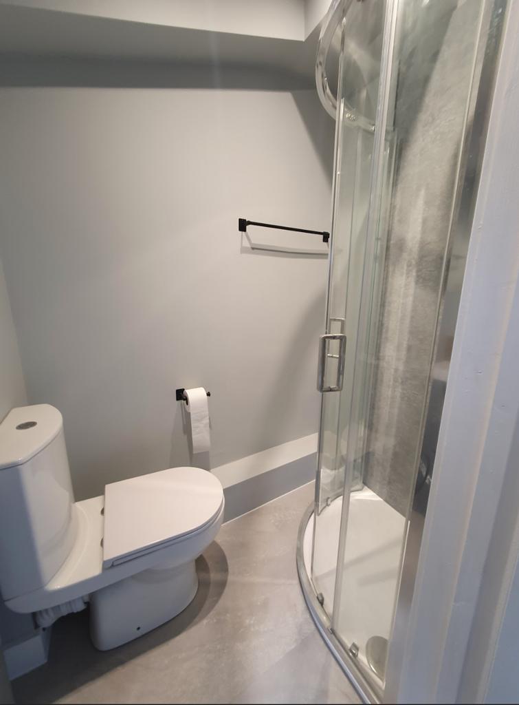 Modern bathroom featuring a sleek shower and co...