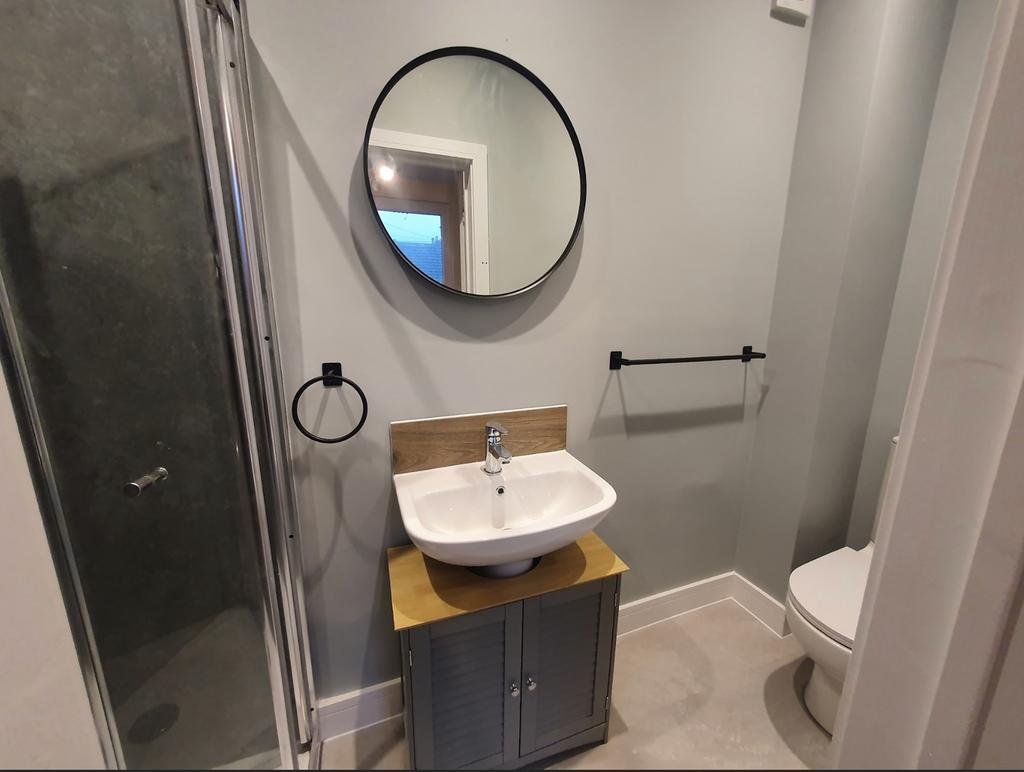 A modern bathroom featuring a stylish shower, c...