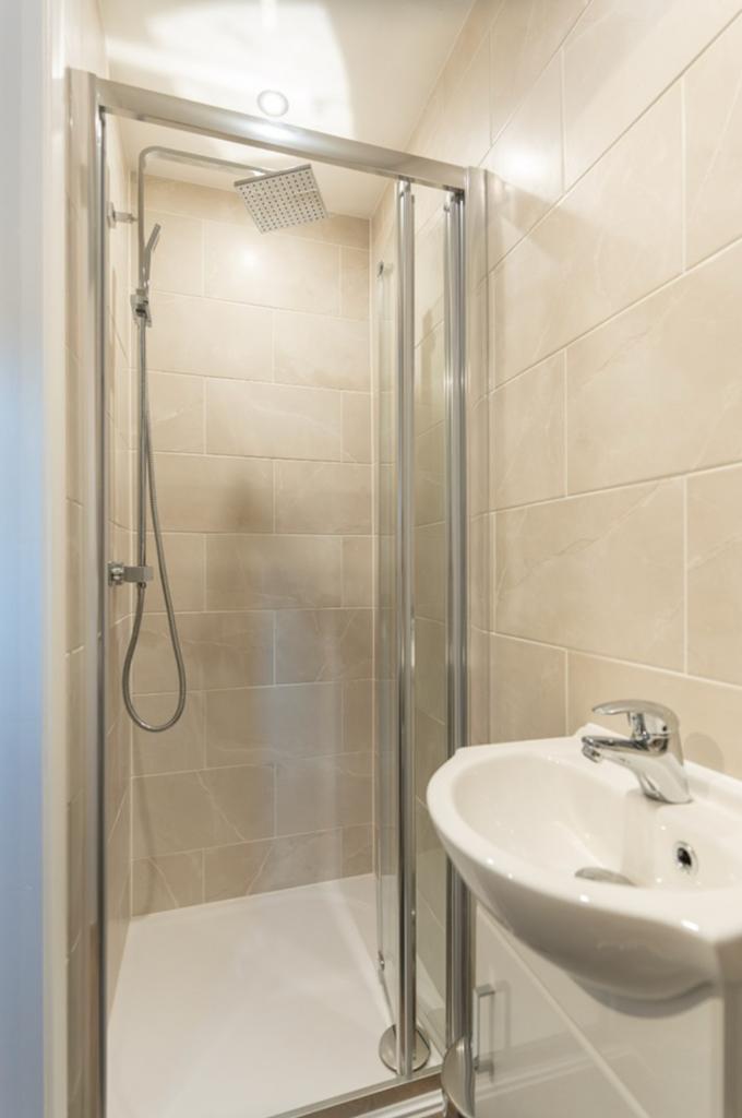 A modern and tidy bathroom featuring a sleek sh...