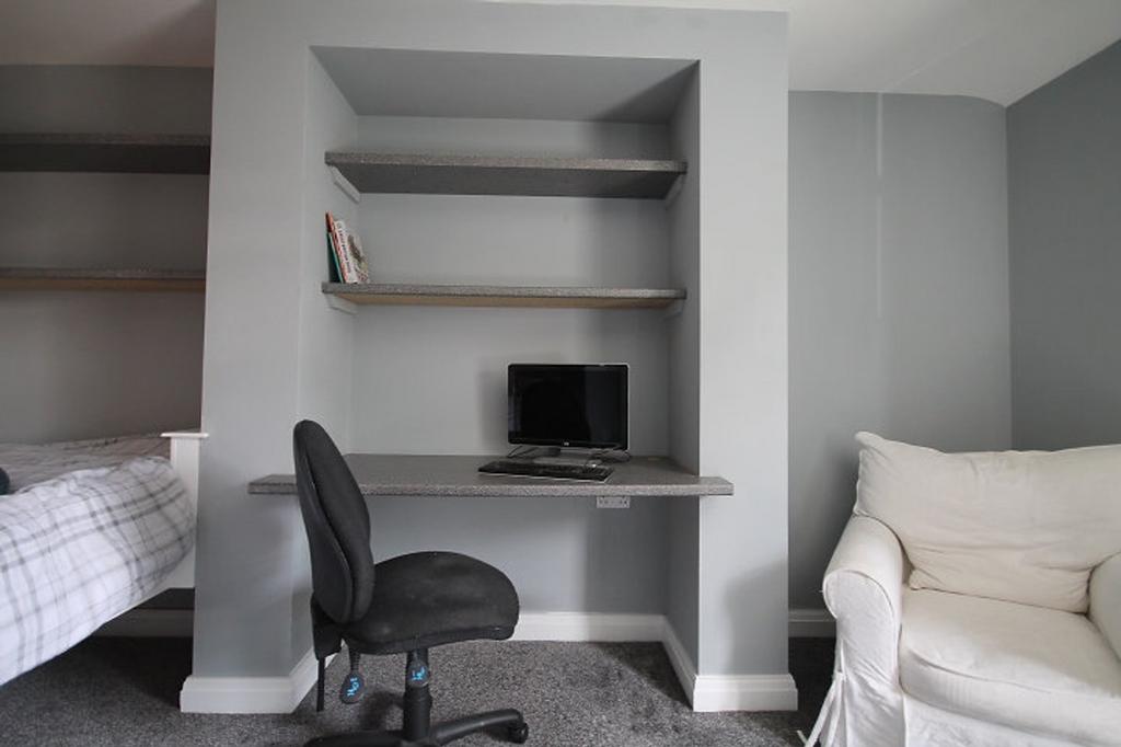 This inviting double bedroom features a cozy be...