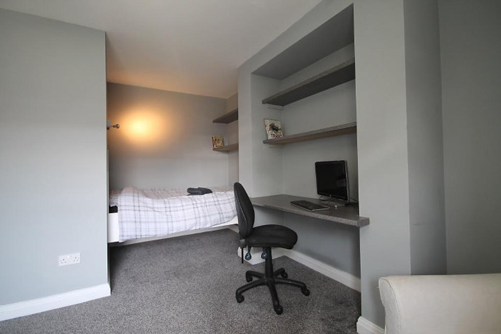 This inviting double bedroom features a comfort...