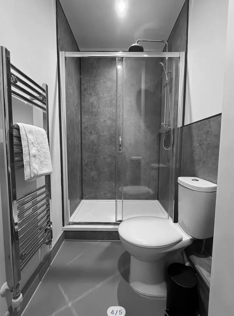A sleek and modern bathroom featuring a spaciou...