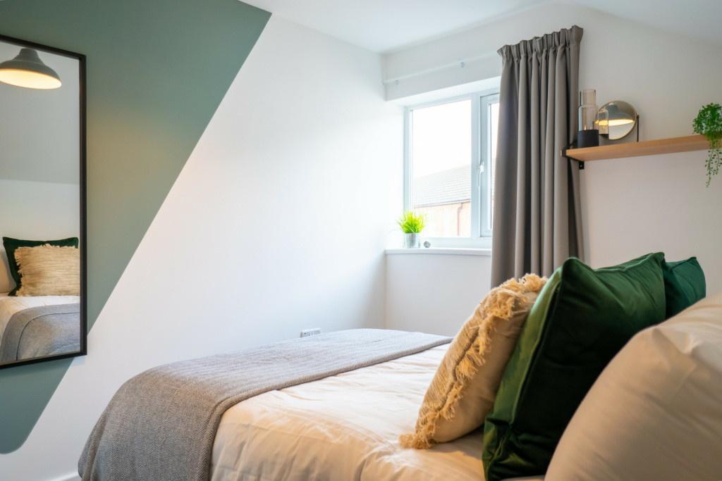 A bright and inviting master bedroom featuring ...