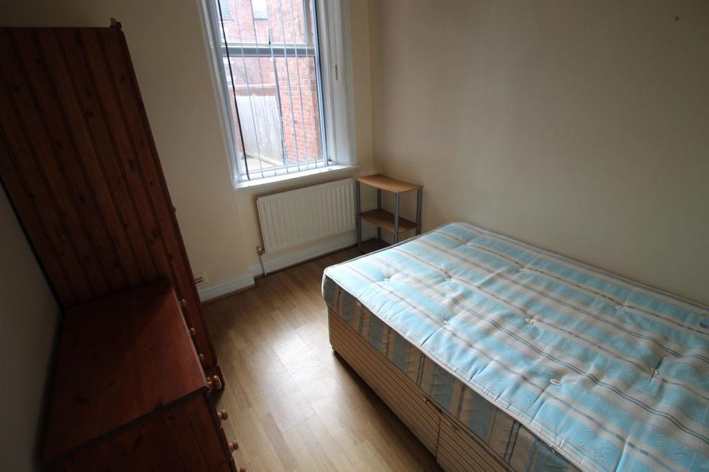 Cozy double bedroom featuring a large window th...
