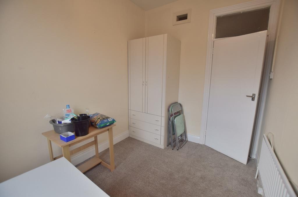 A cozy double bedroom featuring a fitted wardro...