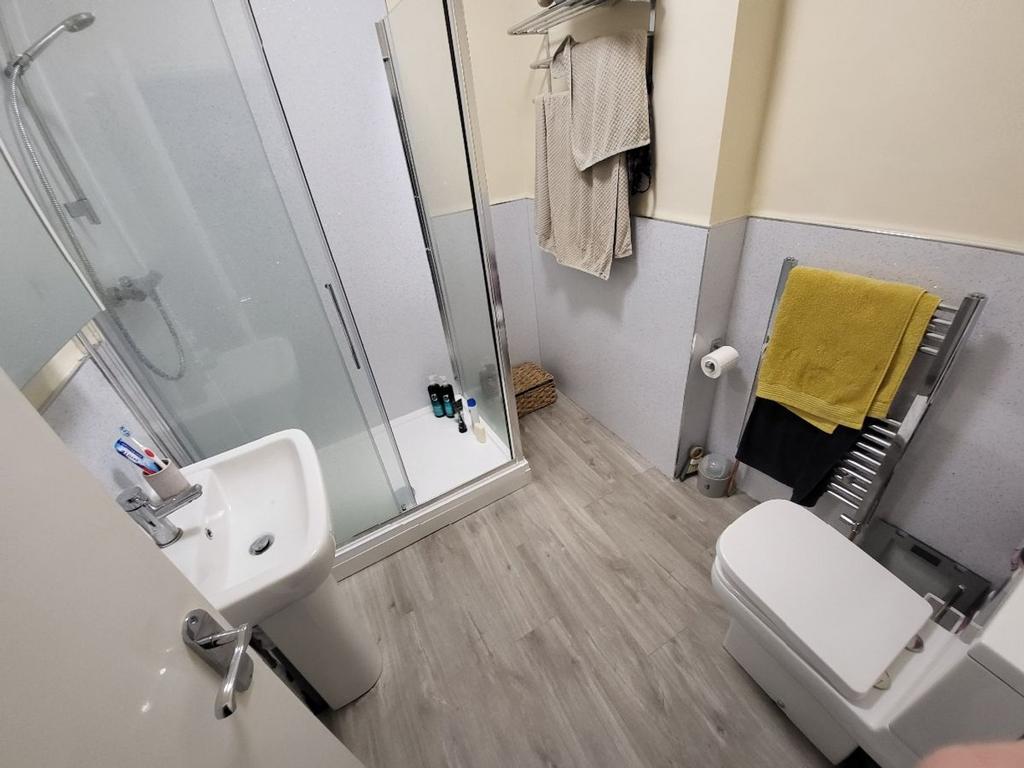 Modern bathroom featuring a spacious shower, sl...