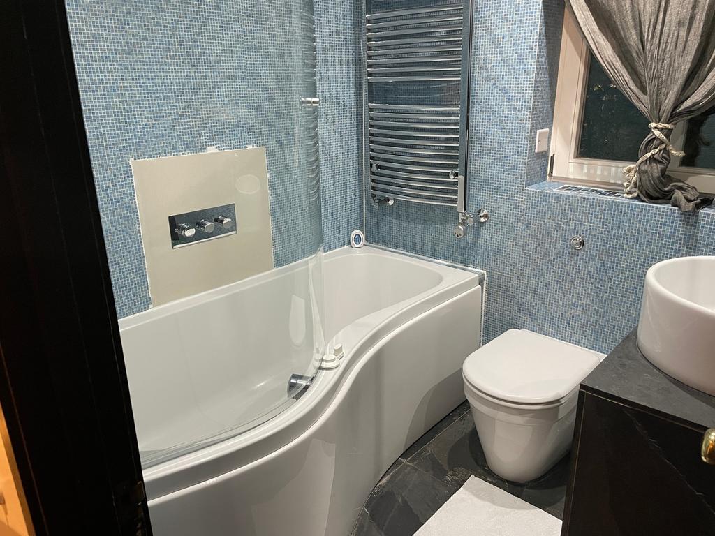 A beautifully designed large bathroom featuring...