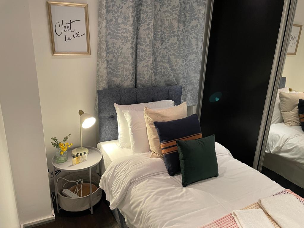 A cozy and well-lit double bedroom featuring st...