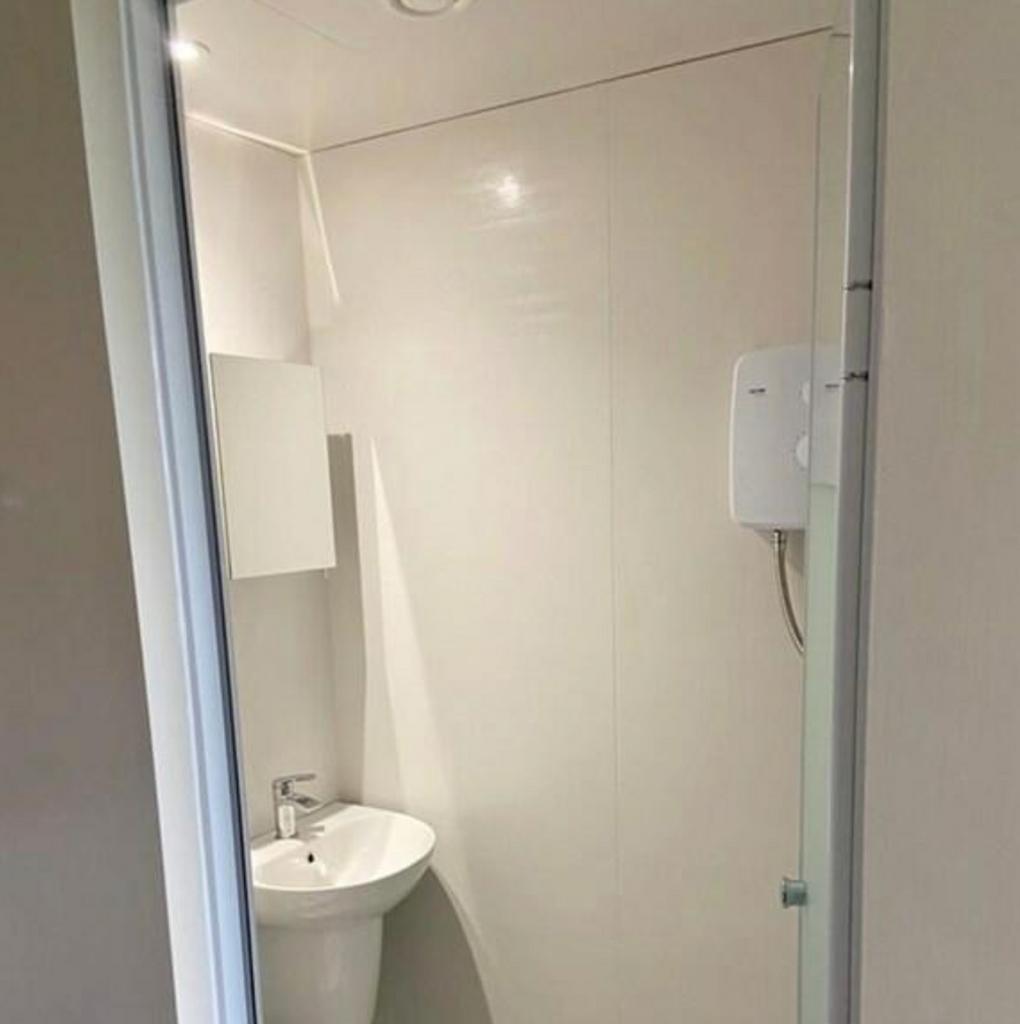 A modern and clean bathroom with a shower, perf...
