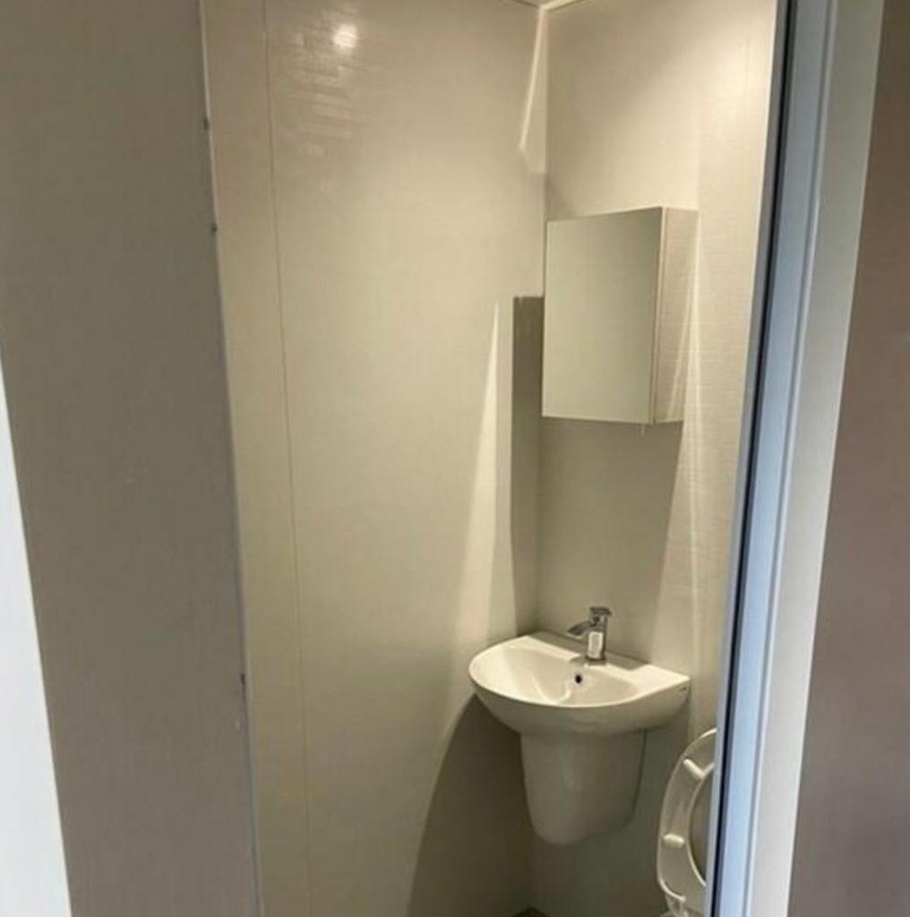 A tidy single toilet with modern fixtures, perf...