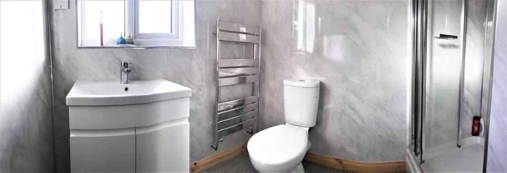 Modern bathroom featuring sleek fixtures and a ...