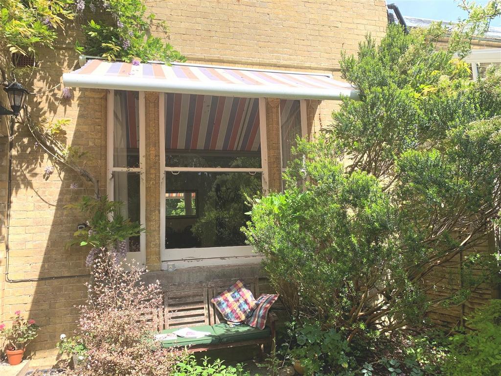 Private garden seating area with awning