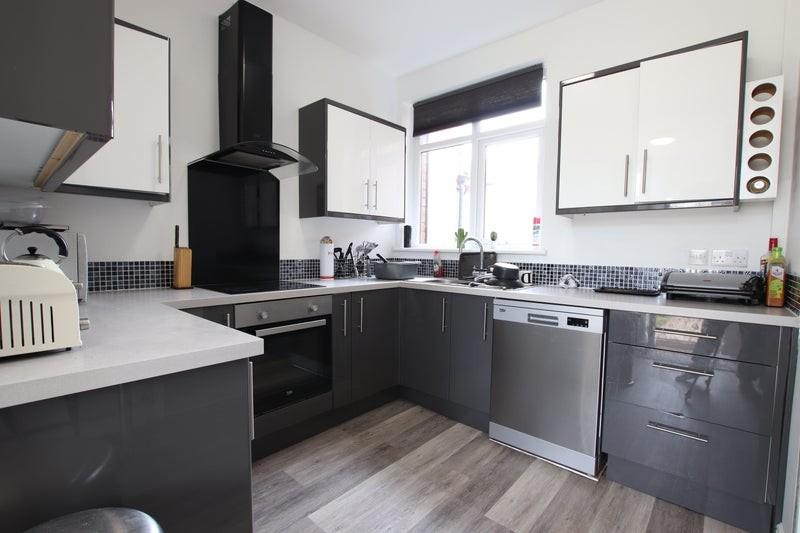 Stylish and modern kitchen featuring sleek cabi...