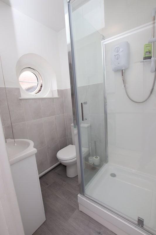 This stylish bathroom features modern fixtures,...