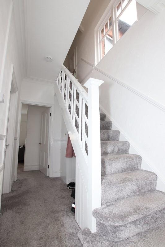 A well-maintained staircase featuring plush car...